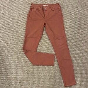 Rust Mid Rise skinny jeans